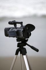 Video camera on tripod at the beach