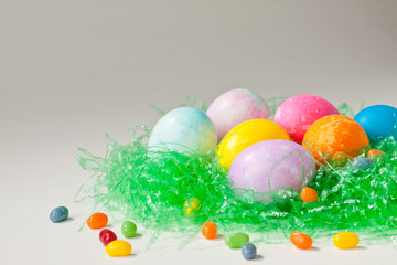 Brightly decorated easter eggs and jelly beans