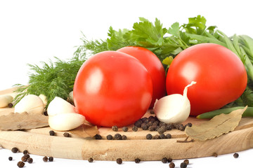 Raw vegetables on cutting board on white background