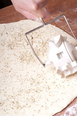 hands in flour closeup kneading dough on table