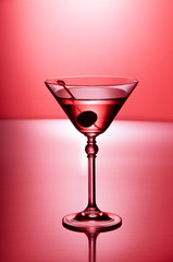 Glass of martini on red