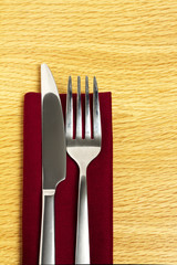 Knife and fork on red napkin