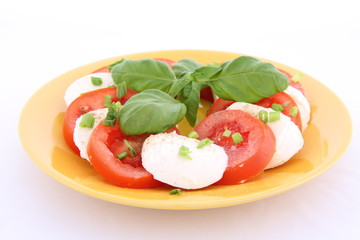 Caprese salad - tomatoes, mozzarella with basil and parsley