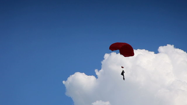 Fying on a parachute and alight on ground