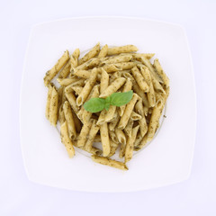 Penne with pesto decorated with basil