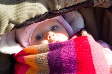 Sleeping chila in baby carriage. Winter.
