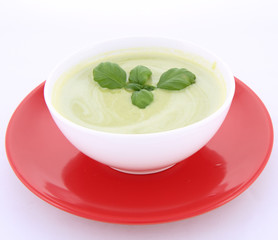 Pea and mozzarella soup decorated with basil