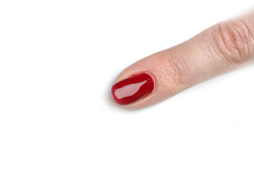 Only one female finger with perfect red spa manicure. isolated o