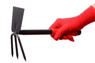 Hand in red gloves with gardening fork