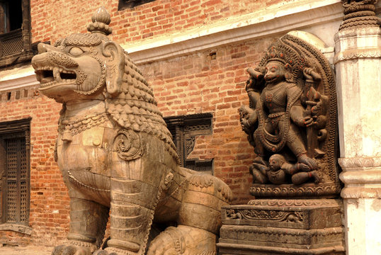 Stone Goddess an d Guardian lion in Hindu temple.
