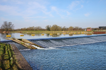 Naklejka premium Floating Barrier on a tranquil blue River