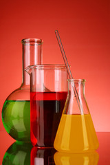 Laboratory glassware on red background