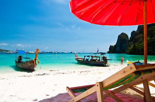 Long tailed boat and Beach chair  at Phi-phi island in Thailand