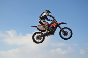 motocross rider jump, blue sky