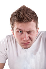 Obraz premium Young man is looking suspiciously with one eye