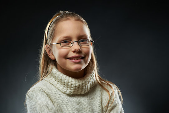 Portrait of a cheerful little girl in eyeglasses