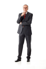Isolated mature business man, standing, hand on chin