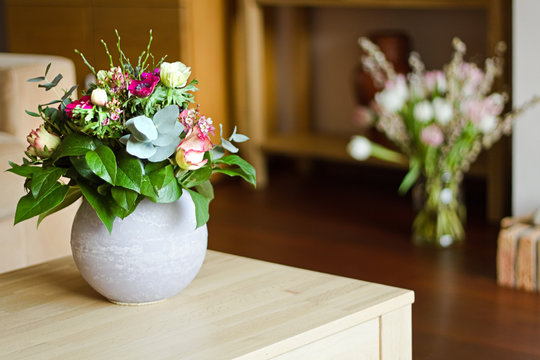 Two vases with flowers in modern interior