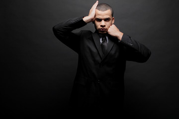 Obraz premium Young businessman in a black suit.