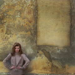 Young girl near yellow wall