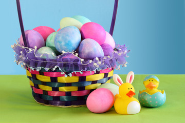 Colorful Easter egg basket with yellow rubber ducks
