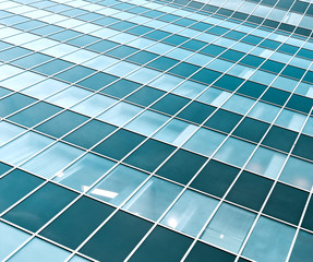 blue transparent textured wall of glass skyscraper in business c