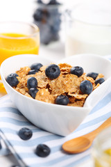 healthy breakfast- cereal with fresh blueberries, juice and milk