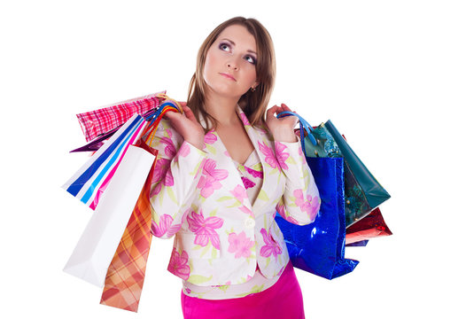 Beautiful woman with shopping bags over white