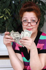 Senior woman counting savings money