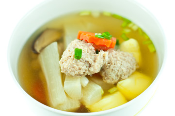 Vegetable soup with pork in white bowl