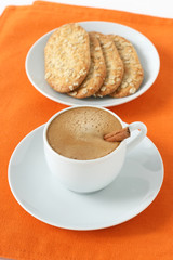 a cup of coffee with cookies