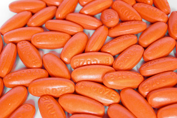 orange vitamin medicine pills closeup