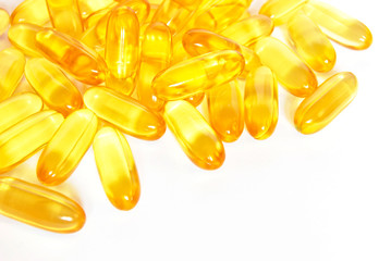 shiny yellow fish oil capsule pills closeup