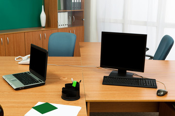 computer and laptop on a desk