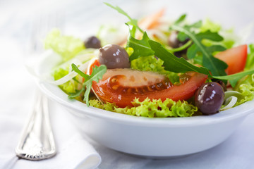 Delicious salad with marinated olives and rocket