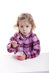 little girl eating youghurt.