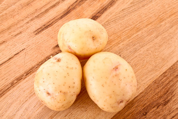 Fototapeta na wymiar Potato on wooden surface