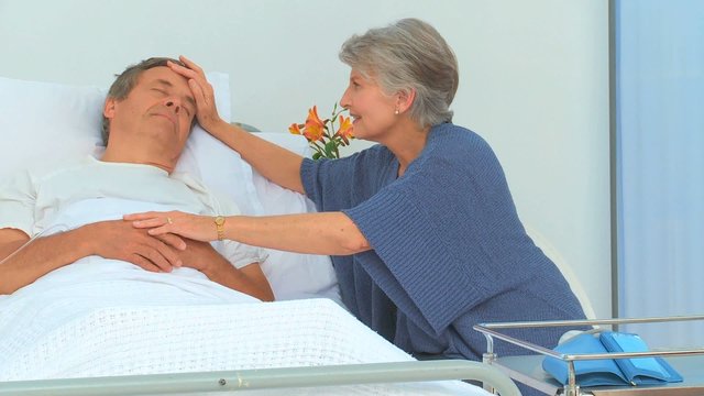 Woman taking her husband's temperature