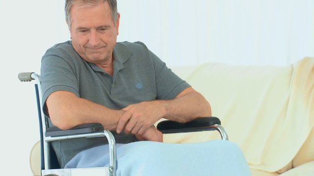 Man in a wheelchair thinking