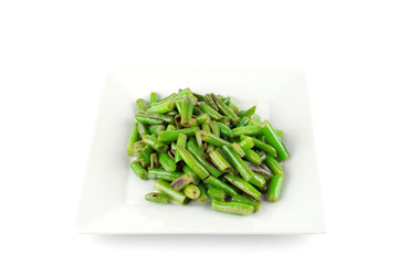 fried string beans on the white plate