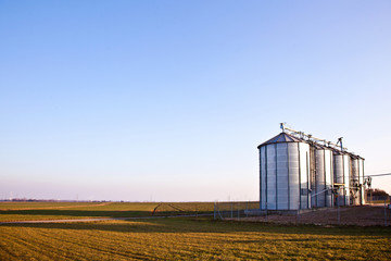 silver silos in the field - Powered by Adobe