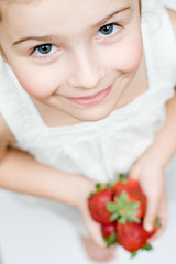 Little girl with strawberries