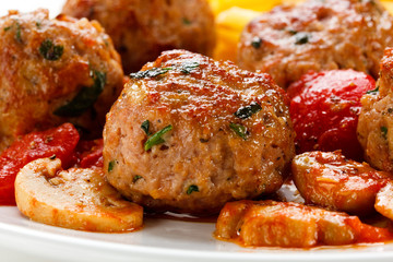 Roasted meatballs, French fries and vegetables