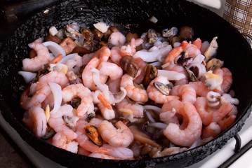 Seafood in a frying pan. Step of cooking