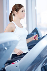 Young woman at the run at gym