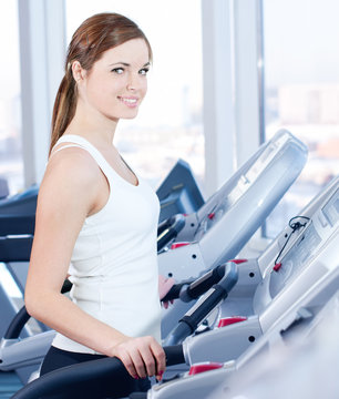 Young woman at the run at gym