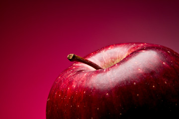 Red apple. Macro. on a red gradient