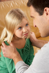 Portrait Of Frightened Daughter Looking At Father