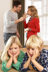 Parents Having Argument At Home In Front Of Children