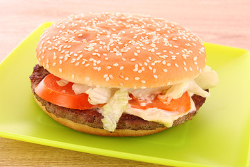 hamburger with vegetables on the table